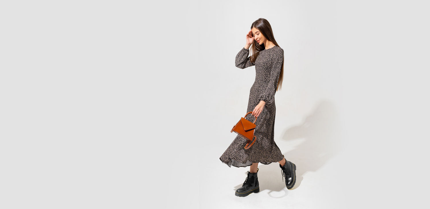 amor fashion woman wearing midi dress with Chelsea boots and bag